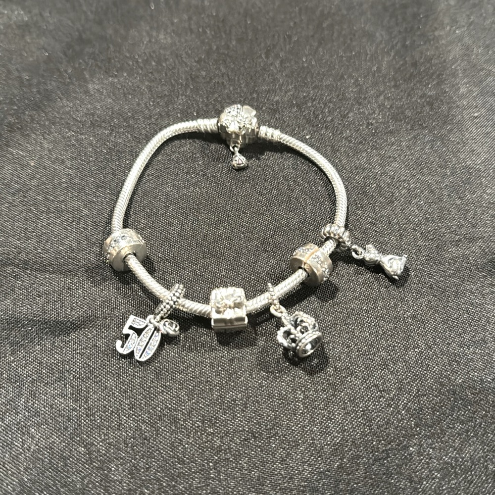 Pandora Bracelet with 4 charms a clover flower clasp.